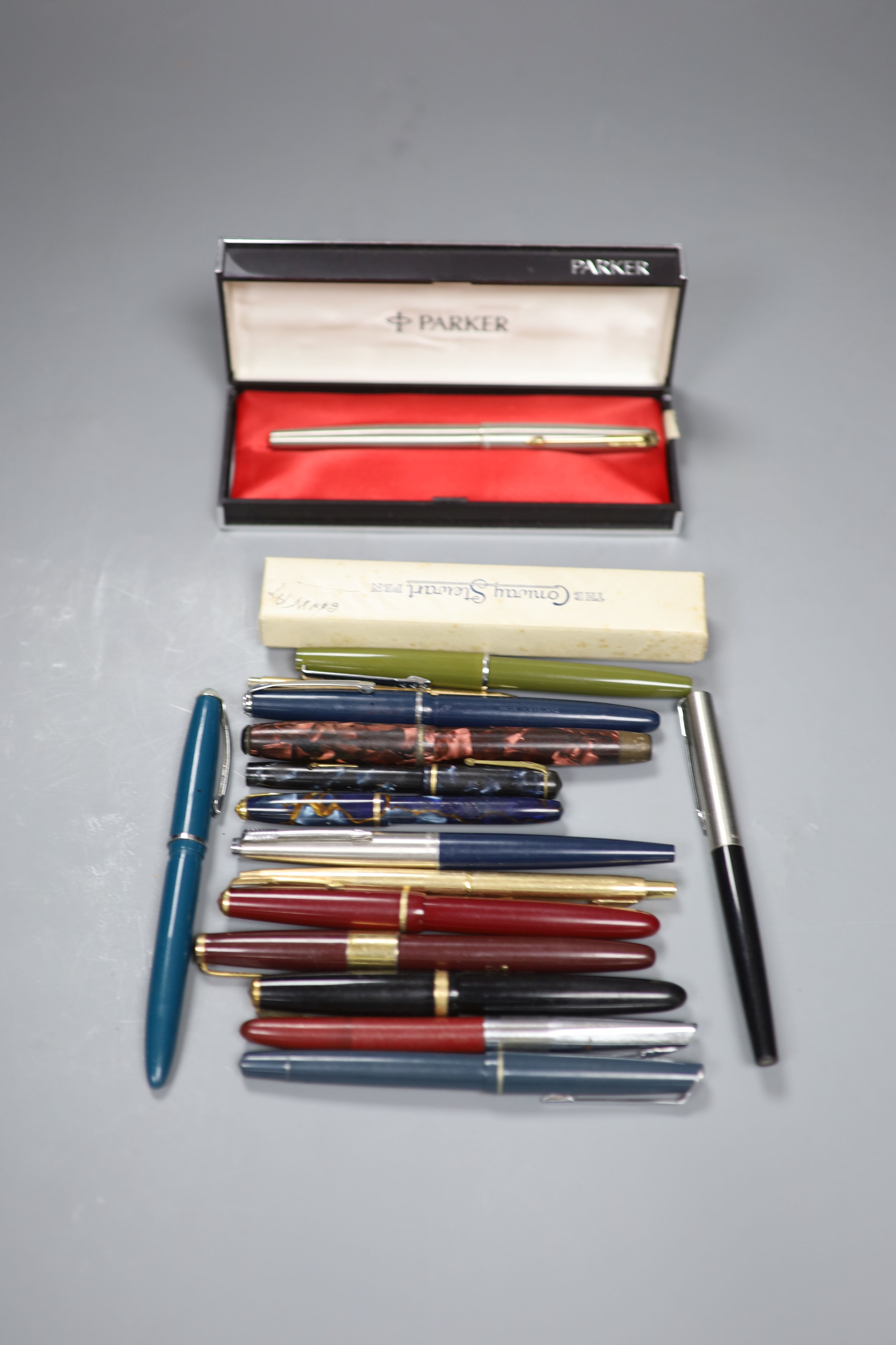 A collection of fountain pens and pencils including a brushed steel Parker 61,